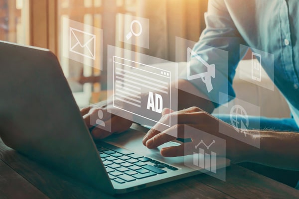 A person uses their laptop to create Google Ads.