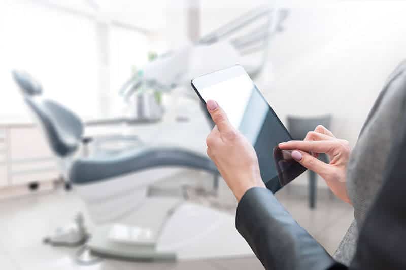 Person Holding Tablet Dental