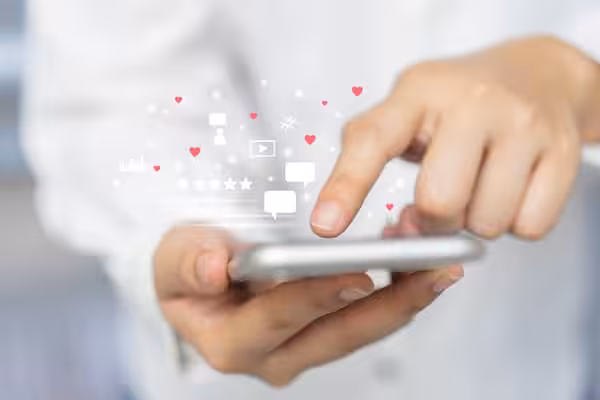 A person uses a mobile phone to browse and interact with social media.